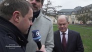 Steffen Hebestreit stellt sich Panorama-Reporter Christian Salewski in den Weg, als dieser Olaf Scholz eine Frage stellen will. © NDR 